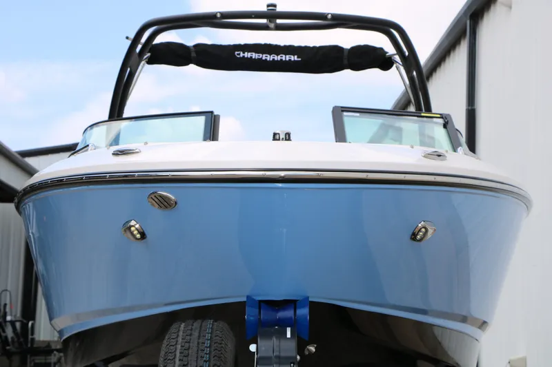 Slide: The Image of 2026 Chaparral 21 SSi boat, blue, front view, on trailer. - 7