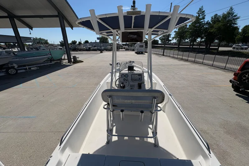 Slide: The Image of 2008 NAUTIC STAR 2110 boat with T-top, parked in a marina. - 10