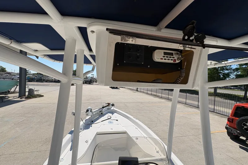 Slide: The Image of 2008 NAUTIC STAR 2110 boat with T-top and radio equipment, parked outdoors. - 11