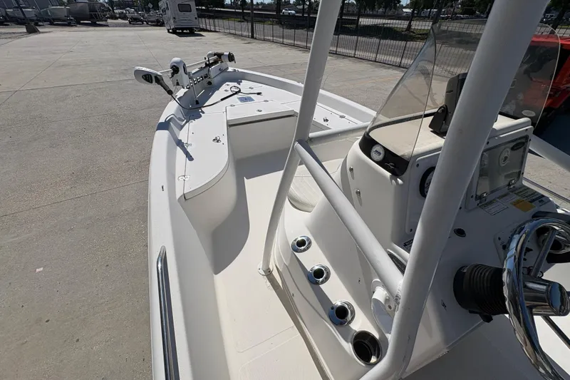 Slide: The Image of 2008 NAUTIC STAR 2110 boat interior with steering console and fishing rod holders. - 12