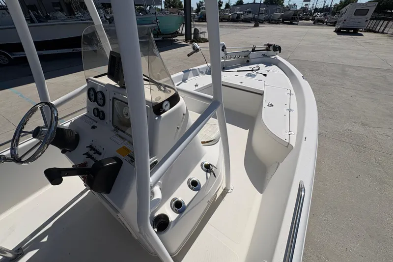 Slide: The Image of 2008 NAUTIC STAR 2110 boat interior with steering console and seating area. - 13