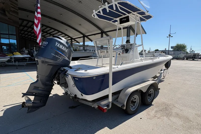 Slide: The Image of 2008 NAUTIC STAR 2110 boat with Yamaha engine on trailer, parked outdoors. - 4
