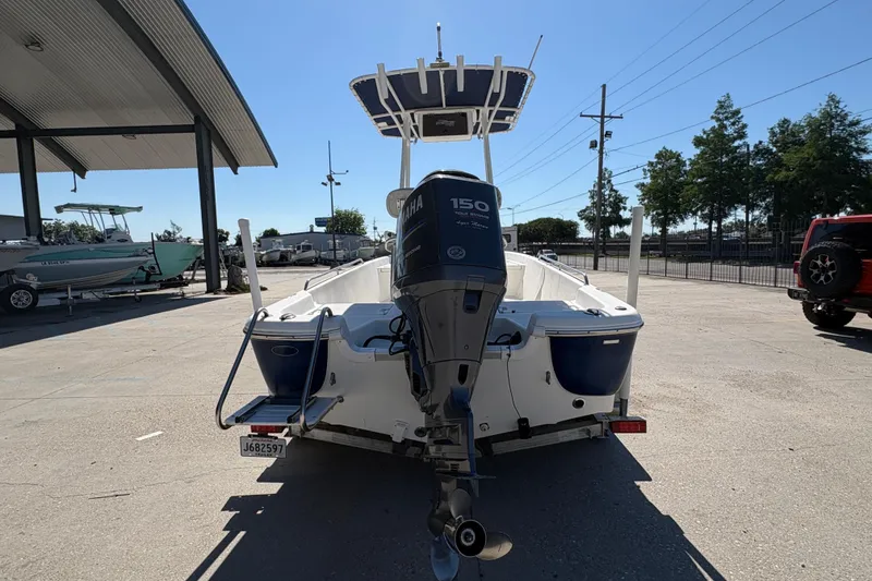 Slide: The Image of 2008 NAUTIC STAR 2110 boat with Yamaha 150 engine, parked outdoors. - 5