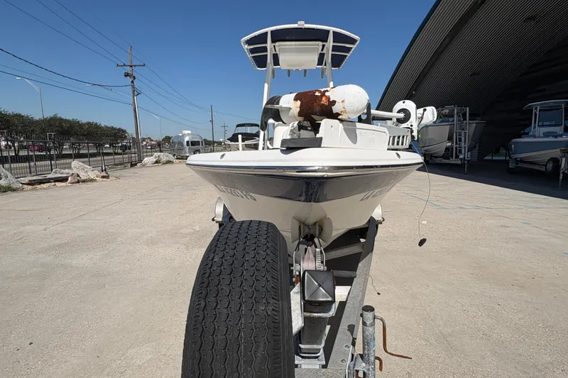 Slide: The Image of 2008 NAUTIC STAR 2110 boat on trailer, parked outdoors under clear blue sky. - 6