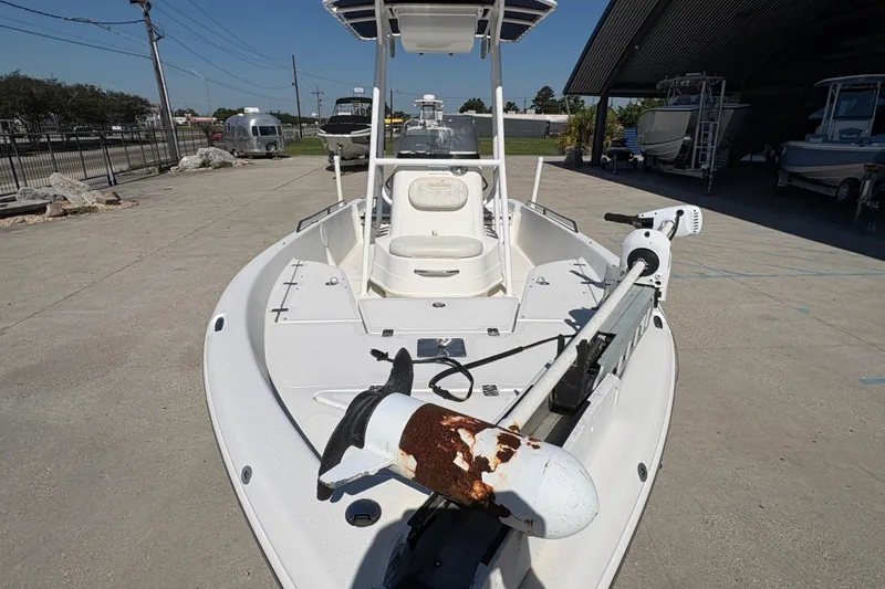 Slide: The Image of 2008 NAUTIC STAR 2110 boat with trolling motor, parked outdoors under clear sky. - 8