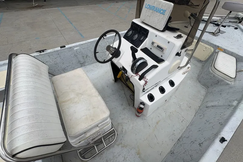 Slide: The Image of 2004 Kenner 18-V boat interior with steering console and seating. - 18