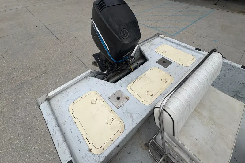 Slide: The Image of 2004 Kenner 18-V boat with outboard motor and seating, viewed from above. - 19