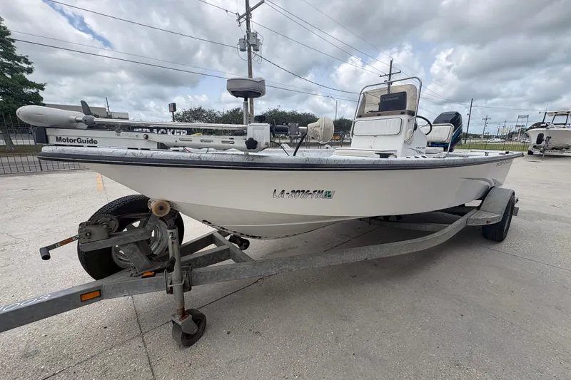 Slide: The Image of 2004 Kenner 18-V boat on trailer with MotorGuide trolling motor, parked outdoors. - 8