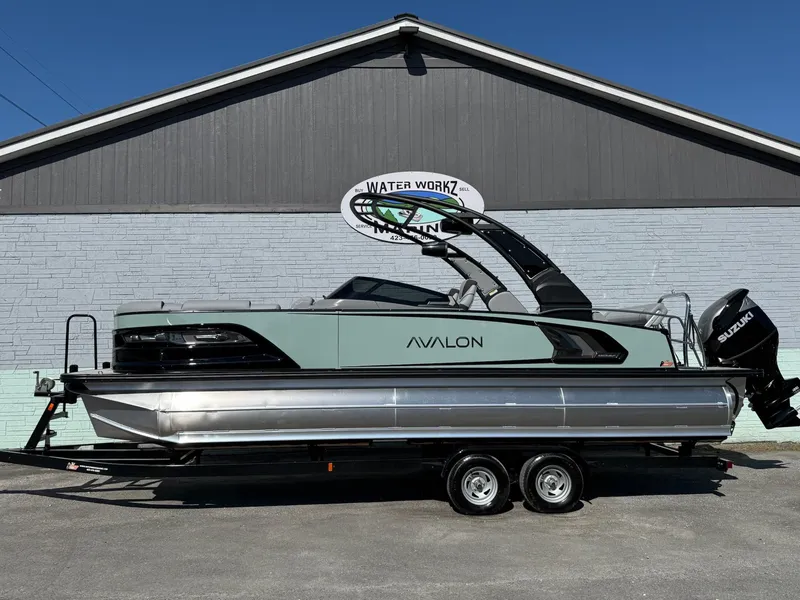 The Image of 2026 Avalon 2585 Excalibur pontoon boat against gray wall. - 1