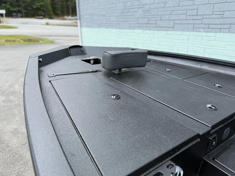 Slide: The Image of Xpress X19 Pro 2026 boat deck with storage and gray surface. - 4