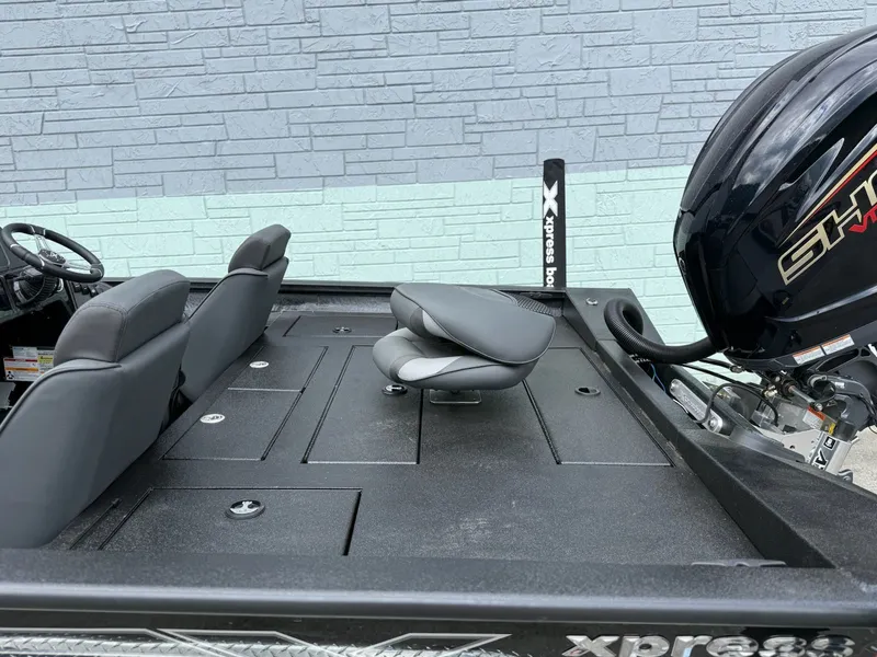 Slide: The Image of Xpress X19 Pro 2026 boat with gray seats and motor. - 6
