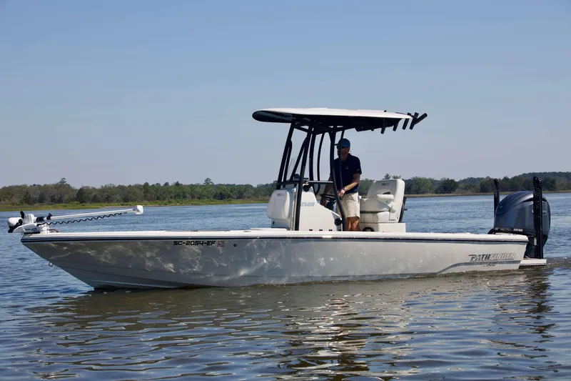 The Image of 2024 Pathfinder 2500 Hybrid boat cruising on a calm lake under clear skies. - 0