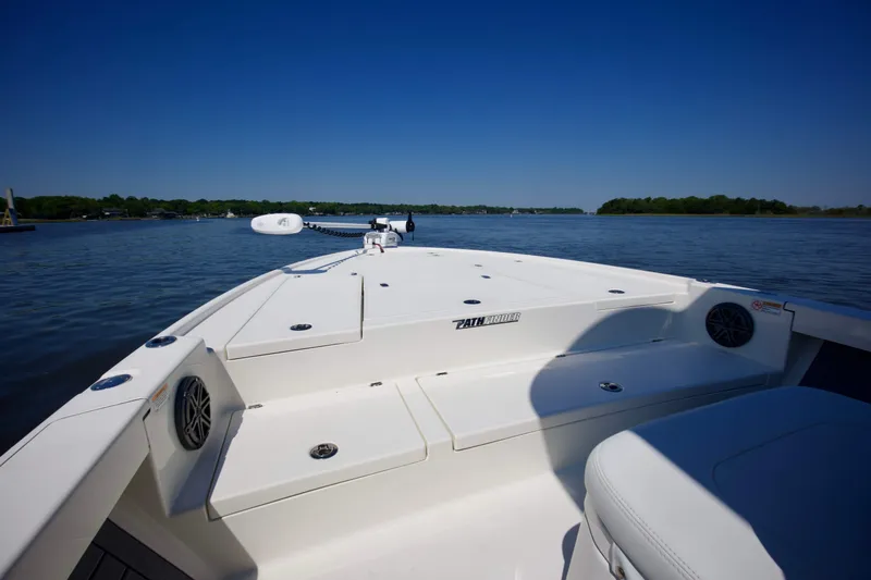 Slide: The Image of 2024 Pathfinder 2500 Hybrid boat on calm water under clear blue sky. - 12