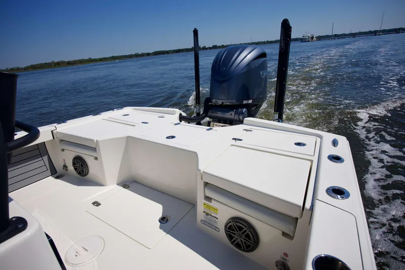 Slide: The Image of 2024 Pathfinder 2500 Hybrid boat on water, showcasing rear deck and motor. - 13