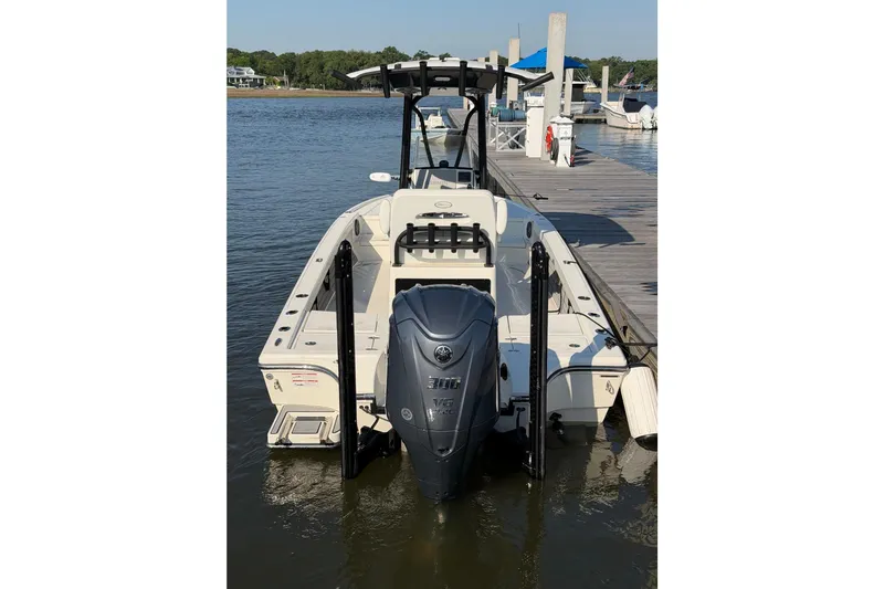 Slide: The Image of 2024 Pathfinder 2500 Hybrid boat docked, featuring a powerful outboard motor. - 15