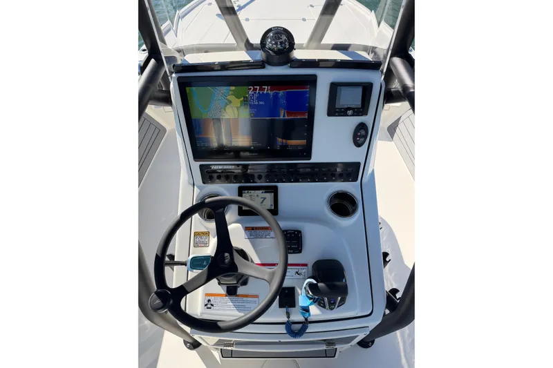 Slide: The Image of 2024 Pathfinder 2500 Hybrid boat console with navigation display and steering wheel. - 19