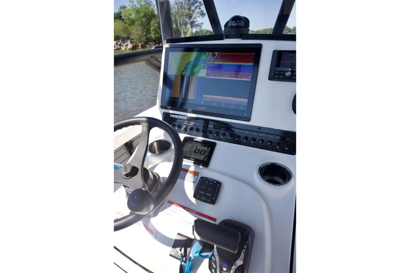 Slide: The Image of 2024 Pathfinder 2500 Hybrid boat dashboard with steering wheel and navigation display. - 20