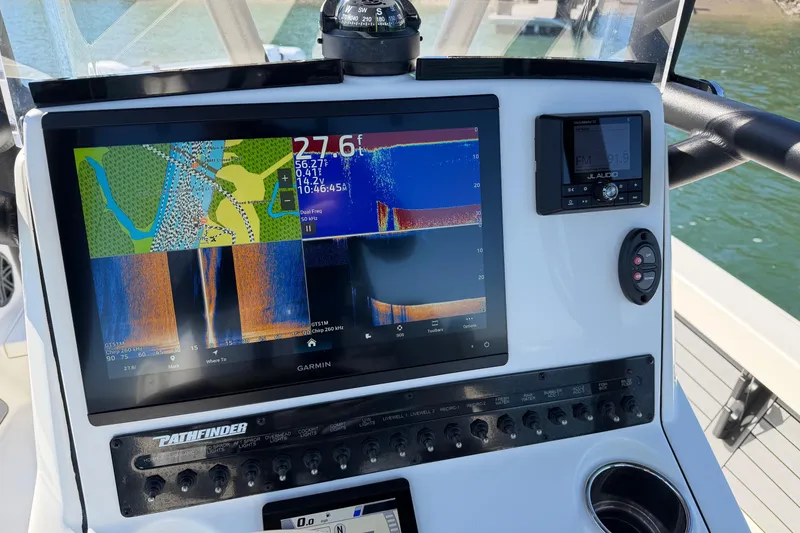Slide: The Image of 2024 Pathfinder 2500 Hybrid boat dashboard with Garmin navigation display. - 21