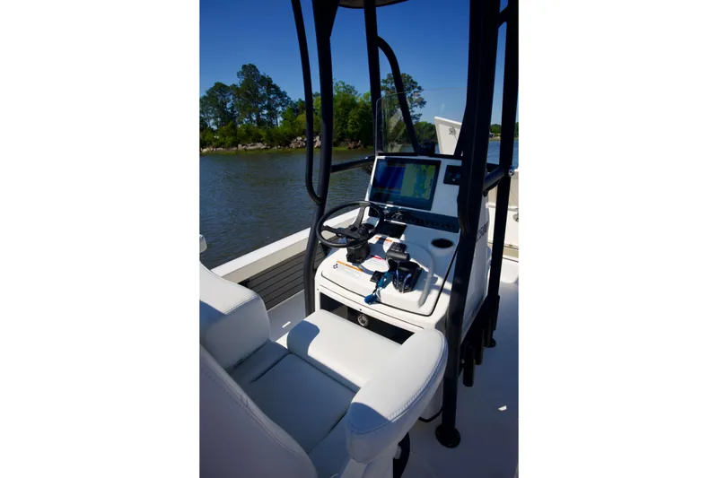 Slide: The Image of 2024 Pathfinder 2500 Hybrid boat cockpit with steering wheel and navigation system. - 23