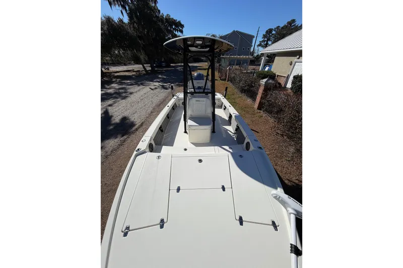 Slide: The Image of 2024 Pathfinder 2500 Hybrid boat, spacious deck, sleek design, parked outdoors. - 28