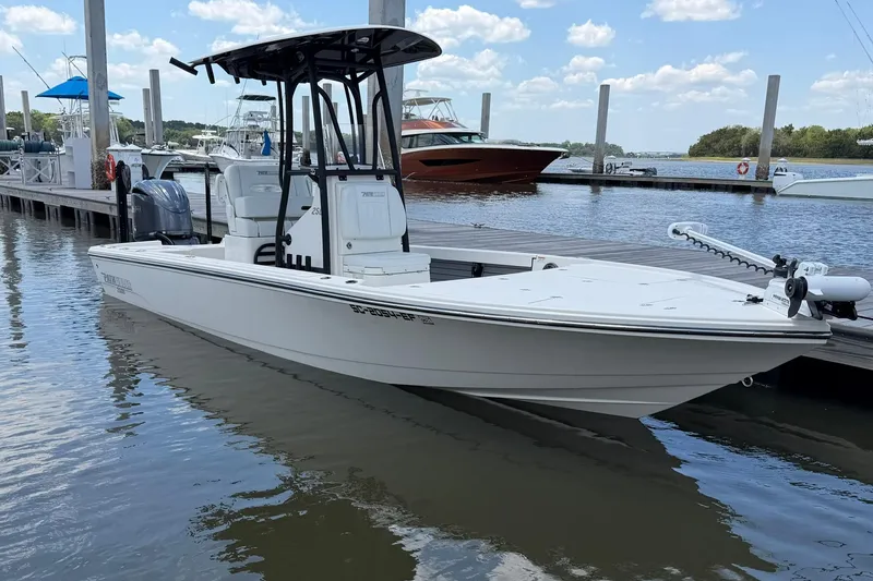 Slide: The Image of 2024 Pathfinder 2500 Hybrid boat docked at marina under blue sky. - 3