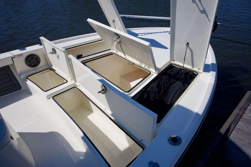 Slide: The Image of 2024 Pathfinder 2500 Hybrid boat with open storage compartments on deck. - 31