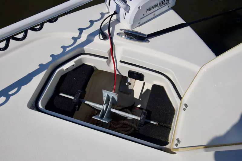 Slide: The Image of Open anchor storage on 2024 Pathfinder 2500 Hybrid boat, featuring Minn Kota trolling motor. - 32