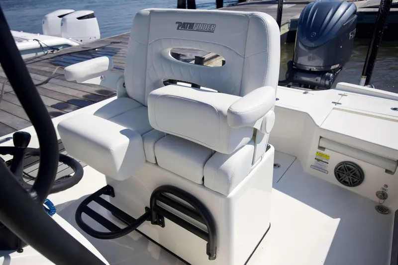 Slide: The Image of 2024 Pathfinder 2500 Hybrid boat seat with armrests, docked by the water. - 36