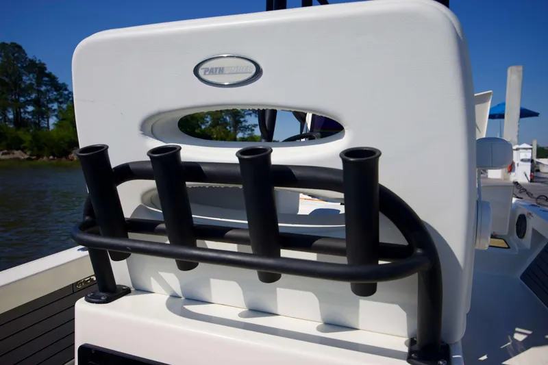 Slide: The Image of 2024 Pathfinder 2500 Hybrid boat with rod holders, docked by a scenic river. - 39