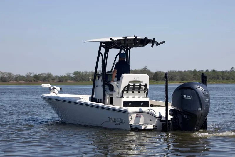 Slide: The Image of 2024 Pathfinder 2500 Hybrid boat cruising on a calm lake with Yamaha engine. - 4