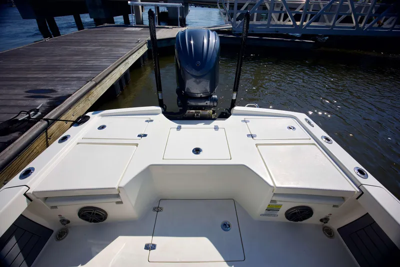 Slide: The Image of 2024 Pathfinder 2500 Hybrid boat docked, showcasing spacious deck and powerful outboard motor. - 42
