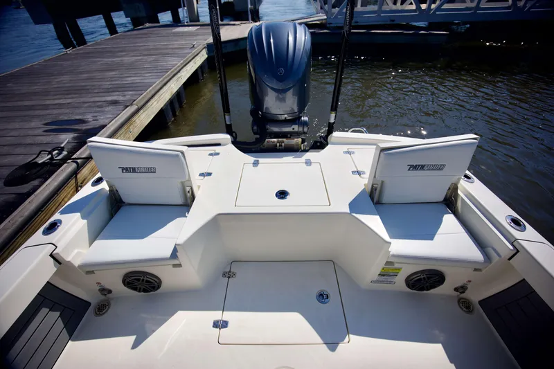 Slide: The Image of 2024 Pathfinder 2500 Hybrid boat interior with seating and motor at dock. - 43