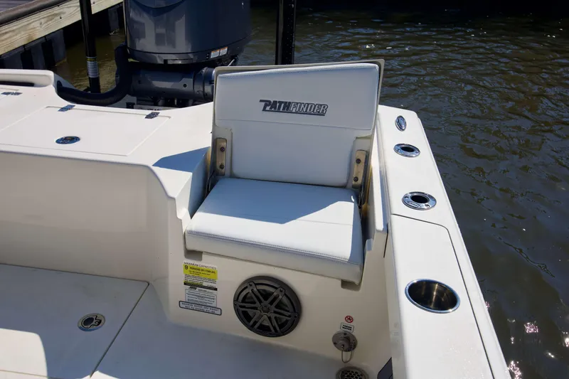 Slide: The Image of 2024 Pathfinder 2500 Hybrid boat seat with logo, cup holders, and water view. - 44