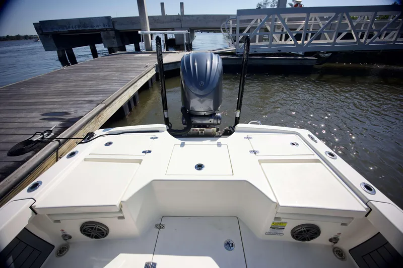 Slide: The Image of 2024 Pathfinder 2500 Hybrid boat docked, showcasing rear deck and outboard motor. - 45