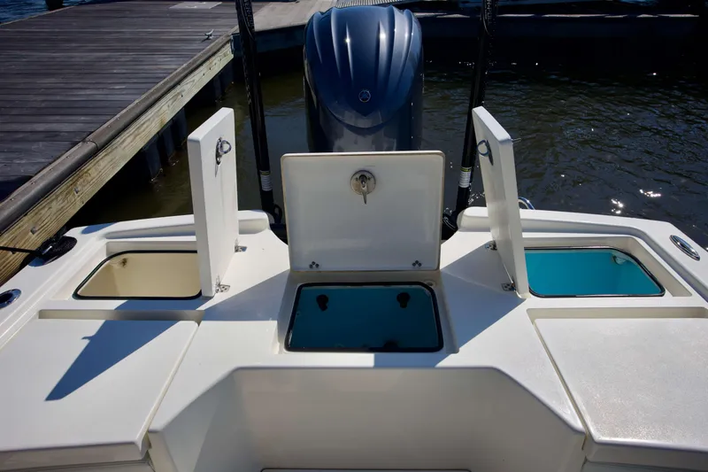 Slide: The Image of 2024 Pathfinder 2500 Hybrid boat with open storage compartments at the dock. - 46