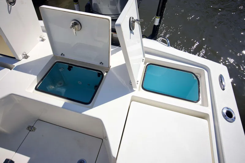 Slide: The Image of 2024 Pathfinder 2500 Hybrid boat storage compartments with open lids, showcasing interior design. - 47