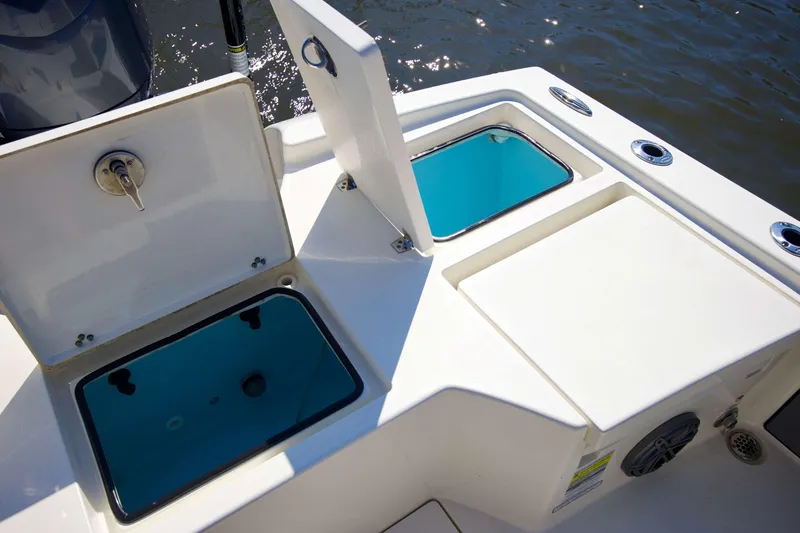 Slide: The Image of 2024 Pathfinder 2500 Hybrid boat with open storage compartments on deck. - 48