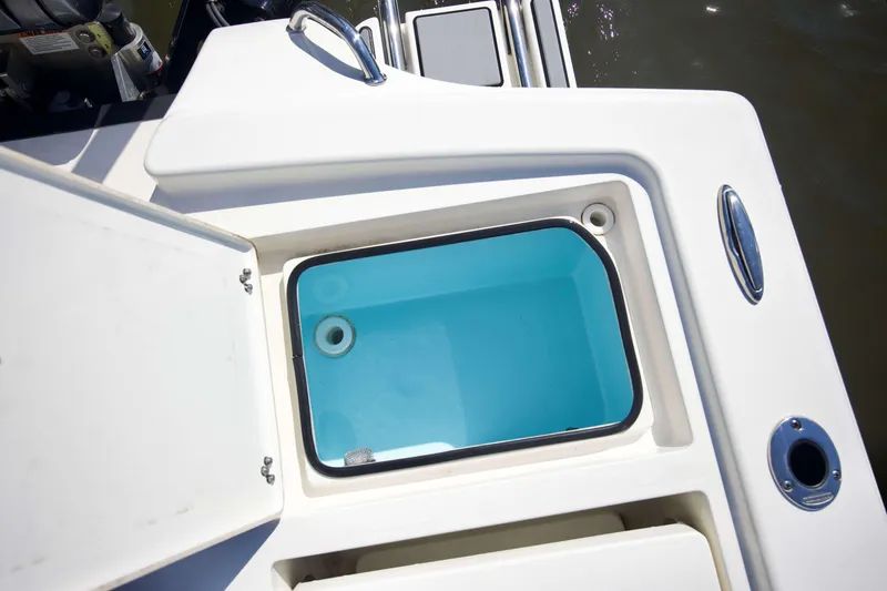 Slide: The Image of Open storage compartment on 2024 Pathfinder 2500 Hybrid boat, featuring a clean, white design. - 49