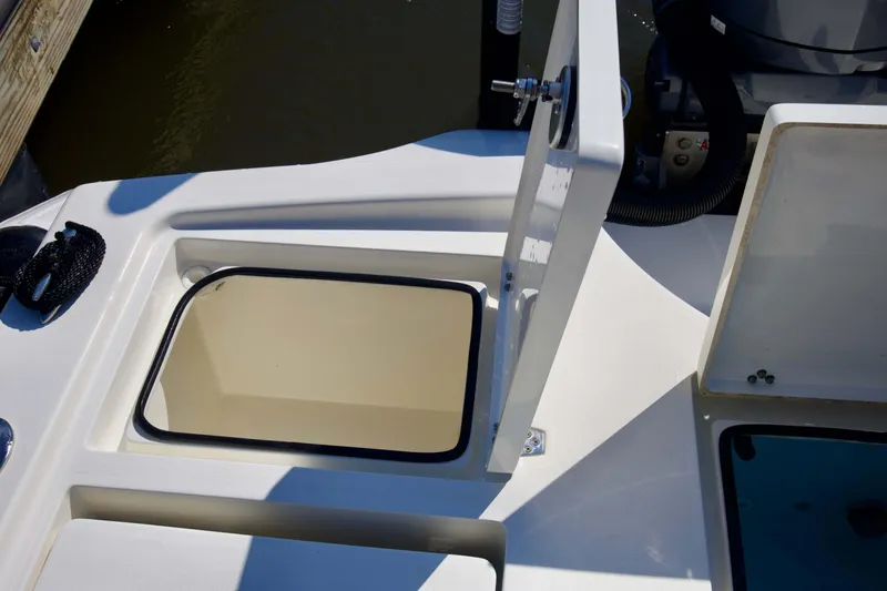 Slide: The Image of 2024 Pathfinder 2500 Hybrid boat storage compartment open on deck. - 50