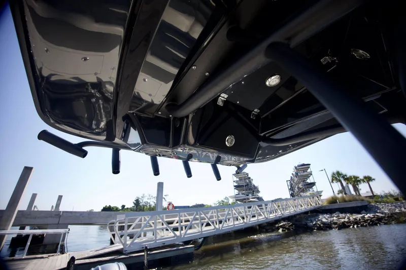 Slide: The Image of Underneath view of 2024 Pathfinder 2500 Hybrid boat at a dockside ramp. - 54
