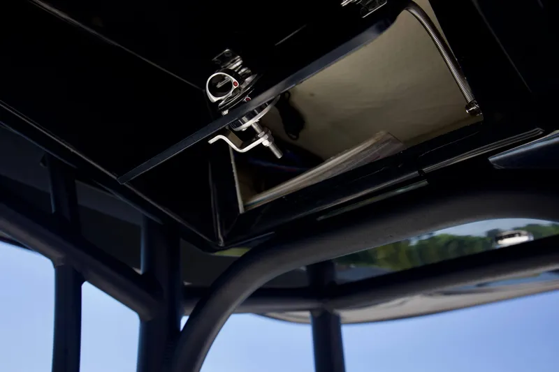 Slide: The Image of 2024 Pathfinder 2500 Hybrid boat interior detail with open compartment and latch mechanism. - 56