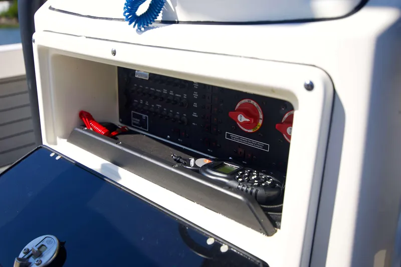 Slide: The Image of Control panel of 2024 Pathfinder 2500 Hybrid boat with switches and communication device. - 59