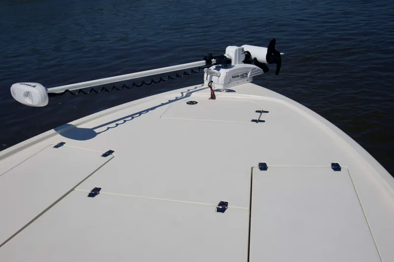 Slide: The Image of 2024 Pathfinder 2500 Hybrid boat deck with Minn Kota trolling motor on calm water. - 60