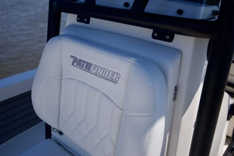 Slide: The Image of 2024 Pathfinder 2500 Hybrid boat seat with logo, featuring white upholstery. - 62
