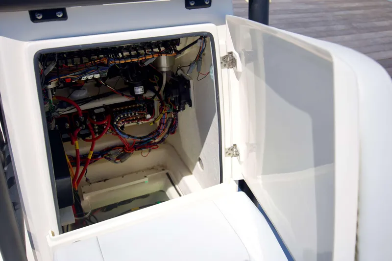 Slide: The Image of Open electrical compartment of 2024 Pathfinder 2500 Hybrid boat, showcasing wiring and components. - 63