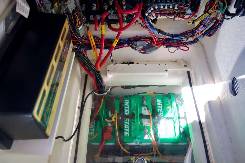 Slide: The Image of 2024 Pathfinder 2500 Hybrid battery compartment with wiring and Interstate batteries. - 65