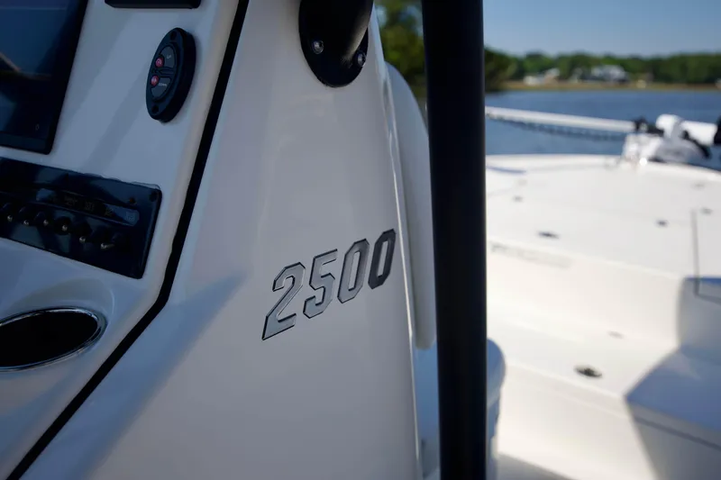 Slide: The Image of 2024 Pathfinder 2500 Hybrid boat console with control panel, docked by the water. - 71