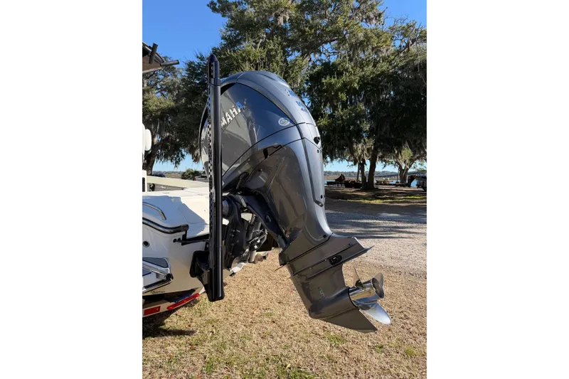 Slide: The Image of 2024 Pathfinder 2500 Hybrid boat with Yamaha outboard motor in a scenic outdoor setting. - 74