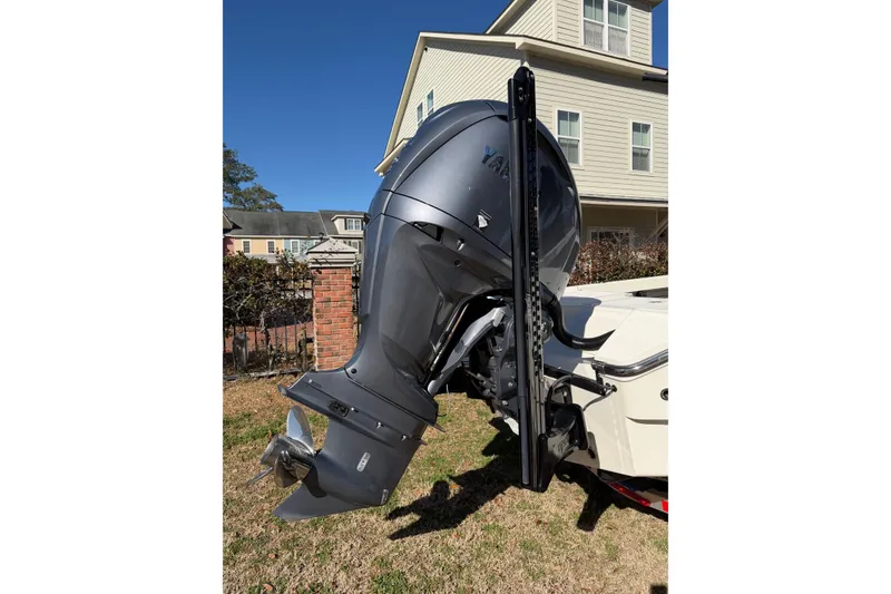 Slide: The Image of 2024 Pathfinder 2500 Hybrid boat with Yamaha outboard motor, parked in residential area. - 75