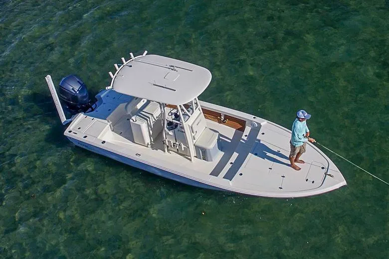 Slide: The Image of Manufacturer Provided Image: 2024 Pathfinder 2500 Hybrid boat on clear water with a person fishing. - 81